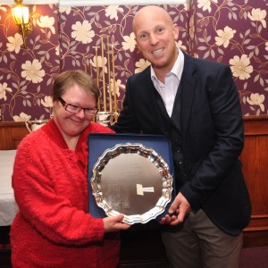Liam Gentry receives the Bernard Dale hill climb trophy from Jenny